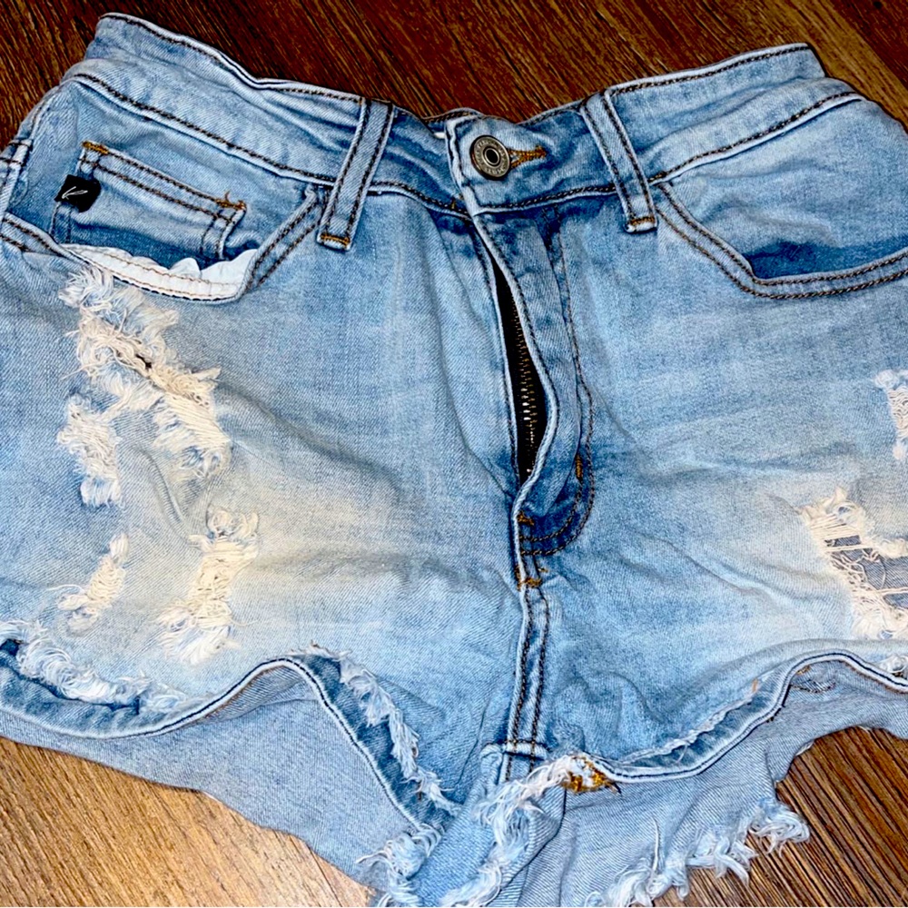 They are light blue Jean shorts with holes in them.